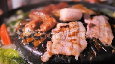 人们用筷子做饭、捡猪肉、翻猪肉，在火锅上用深色和谷物的方法<strong>迎接</strong>韩国烧烤